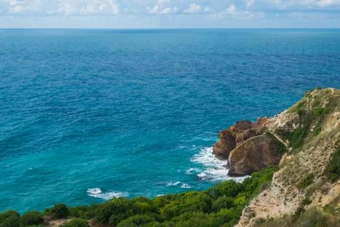 View from the mountain to the waves of the sea. Stock Photos