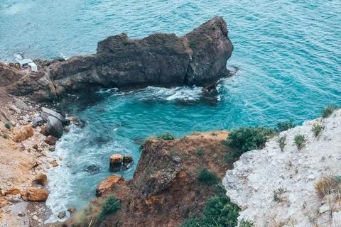 View from the mountain to the waves of the sea. Stock Photos