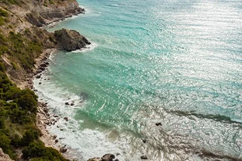 View from the mountain to the waves of the sea. Stock Photos