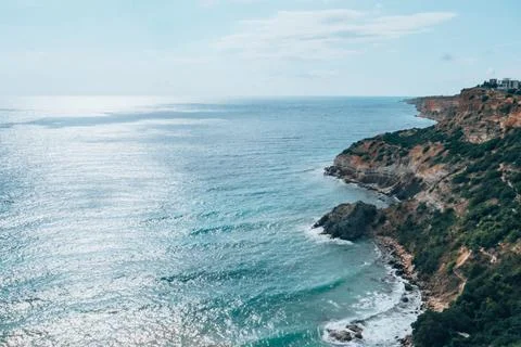 View from the mountain to the waves of the sea. Stock Photos