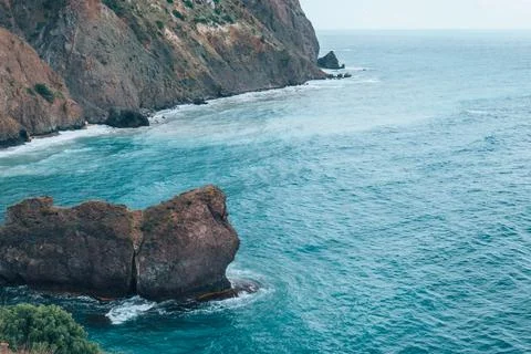View from the mountain to the waves of the sea. Stock Photos