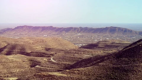 View Of The Mountainous And Desert Terrain With Distant Town Stock Footage 126670741