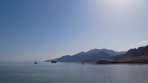 View Of A Mountainous Seashore With Several Motor Boats In Calm Weather Stock Footage 221618906