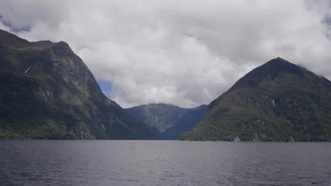 View of mountains above channel at Doubtful Sounds 스톡 동영상 327764740