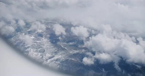 View of mountains from airplane window. Beautiful scenery from plane window Video stock 162510060
