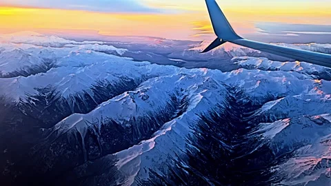 A view of the mountains from an airplane wing Stock Footage 274835771