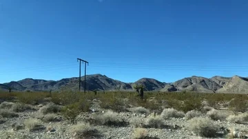View of mountains and fields from inside a moving car Stock Footage 85963869