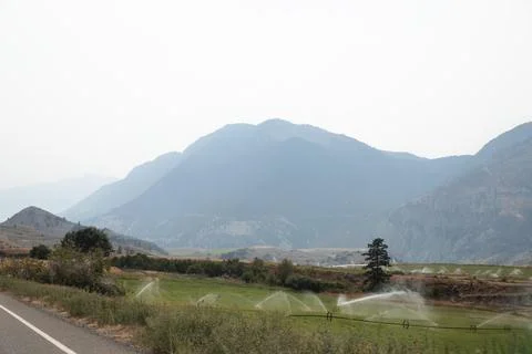 View of the mountains and irrigation of fields in Kamloops. Canada. Stock Photos