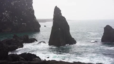 View of mountains and ocean waves and birds in Iceland Stock Footage 258263306
