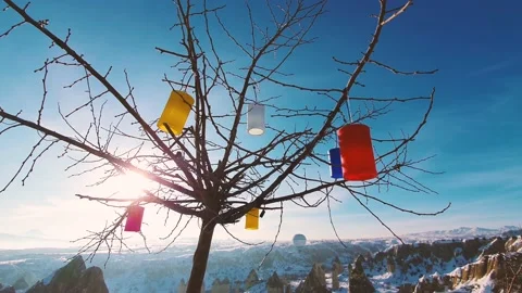 View of the mountains and the tree decorated with colored lanterns. Stock Footage 139619600