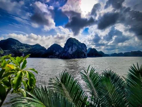 View of mountains and water with clouds in the background at a coastal area Stock Photos