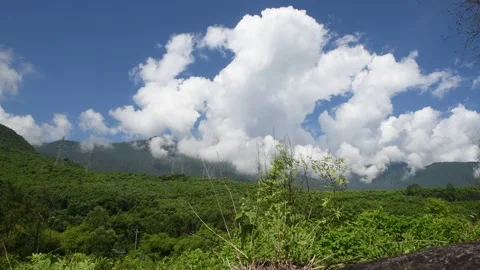 View of mountains with clouds and a passing train. Video stock 296490340