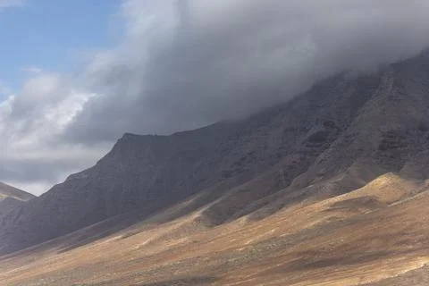 View of mountains with clouds at Playa de Cofete, Fuerteventura, Canary Islan Stock Photos