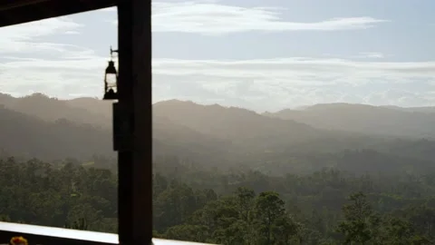 View on mountains with dense misty forest from the moutain hotel terrace Stock Footage 208426970