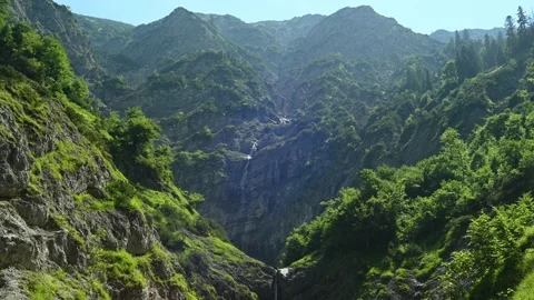 View on the mountains in the end of a beautiful valley with waterfalls Video stock 211503699