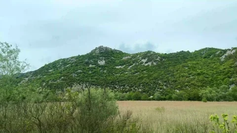 View of the mountains in Montenegro on a cloudy day from a passing car. Stock Footage 273192475