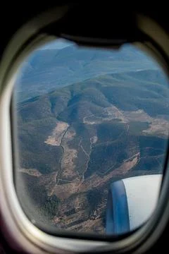 View of the mountains from the plane window. View from a height. Earth and sk Stock Photos