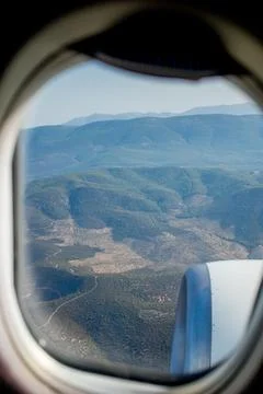 View of the mountains from the plane window. View from a height. Earth and sk Stock Photos