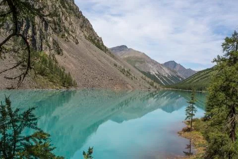 View of the mountains with reflection in the blue lake. Stock Photos