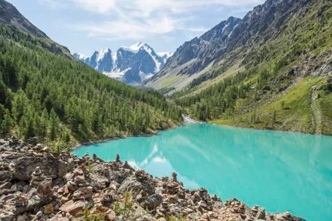 View of the mountains with reflection in the blue lake. Stock Photos