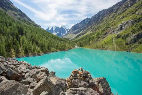 View of the mountains with reflection in the blue lake. Stock Photos