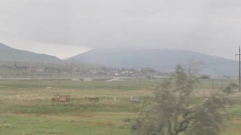 View of mountains, road and small town from the moving transport Stock Footage 168310859