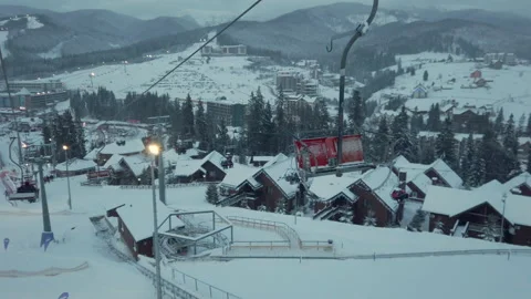 View on mountains. Ski resort in winter, cottage houses along ski tracks Stock Footage 148449881