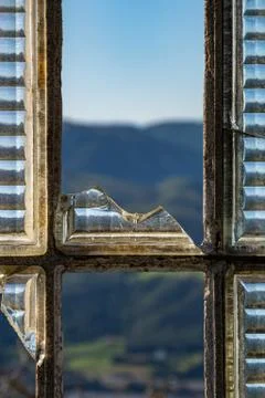 View of the mountains through the broken window in abandoned building Stock Photos