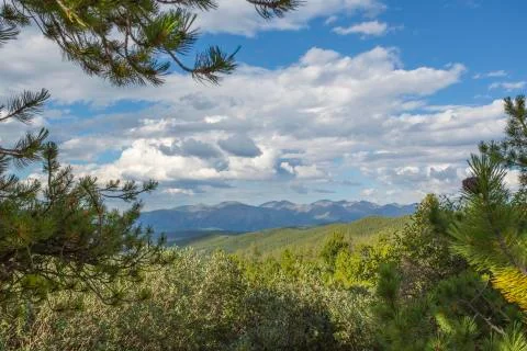View of the mountains through the field. Stock Photos