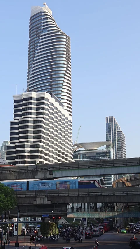 View of moving BTS skytrain near Chit Lom metro station. Vertical video. Stock Footage 284091490
