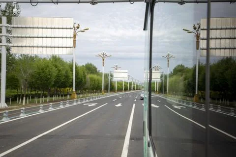View from a Moving Bus Window Driving Along a Scenic Tree-Lined Road Stock Photos