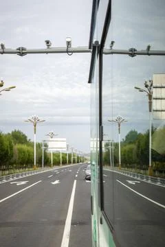 View from a Moving Bus Window Driving Along a Scenic Tree-Lined Road Stock Photos
