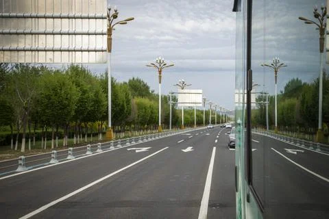 View from a Moving Bus Window Driving Along a Scenic Tree-Lined Road Stock Photos