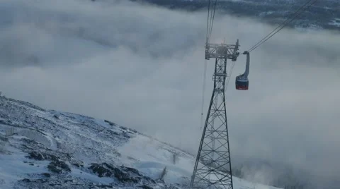 View from moving cabin on oncoming tower of cable car and setting sun. Sweden Video stock 64921630