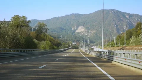 View from a moving car. highway among the mountains in summer. mountain peak Stock Footage 140362979