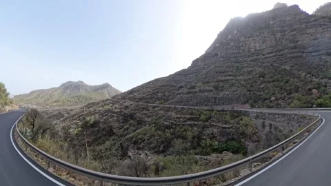 View from a moving car on a mountain road and surrounding landscape. Stock Footage 285211987