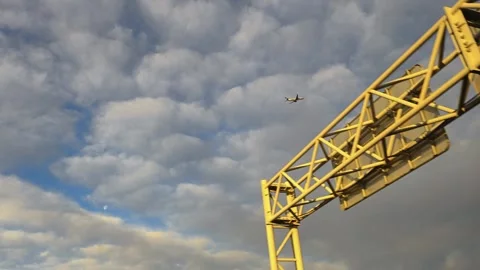 View from moving car of plane flying to airport. Airplane flying away. Stock Footage 332390662