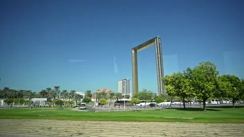 A view from a moving car on Sheikh Zayed Road, showcasing the Dubai Frame i.. Stock Footage 297938279