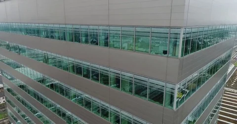 The view from moving down copter at the modern glass building in Austria Stock Footage 82242090