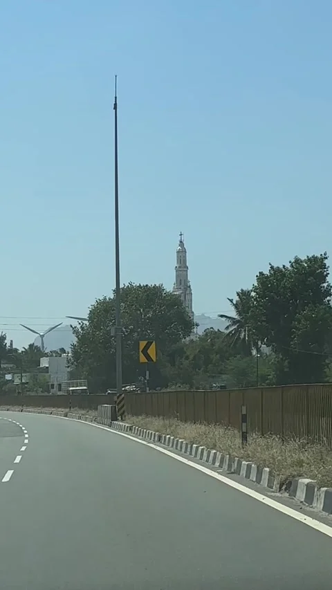 View from a moving object to the road, church and wind turbines Stock Footage 321753089