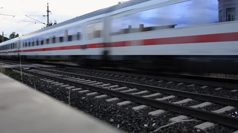 View of a moving passenger train across a railway crossing in Austria. Stock Footage 150583069