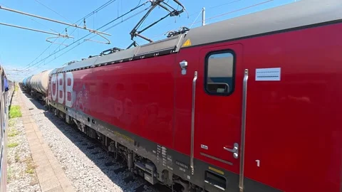 View from a moving passenger train as a freight train passes Stock Footage 339806104