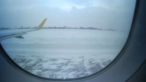 View from the moving Pegasus airplane window on the snowy airport Stock Footage 152604445