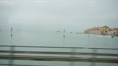 View from moving train of busy Venice water traffic and transportation hub 스톡 동영상 325777913