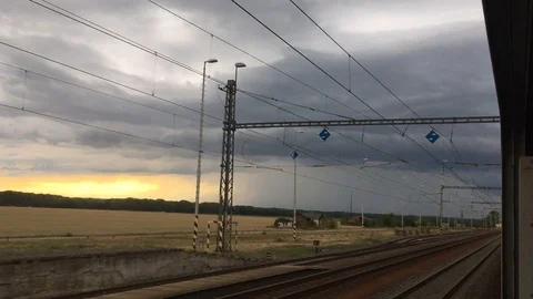 View from a moving train with dramatic sunset and rain storm in Czech countrysid Stock Footage 104802798