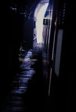 View from moving train inside dark tunnel with light at exit railway journe.. 写真素材