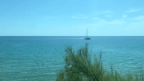 View from a moving train of the Mediterranean Sea near Nice, Cote d'Azur Stock Footage 345447050