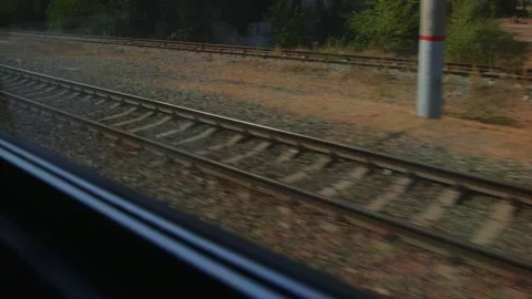 View from A moving train showing parallel railway tracks. A Concrete platform Stock Footage 318907348