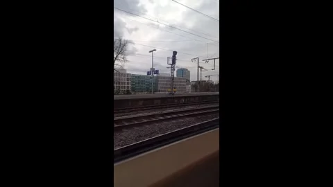 View from moving train window of railway tracks and city buildings in Cologne. Stock-Footage 336466462