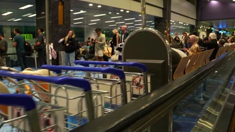 View from a moving walkway, capturing a diverse group of travellers standing Stock Footage 341658038